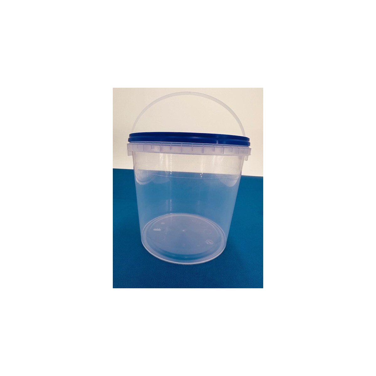 Empty bucket, transparent with a blue lid, 1.2 liters.